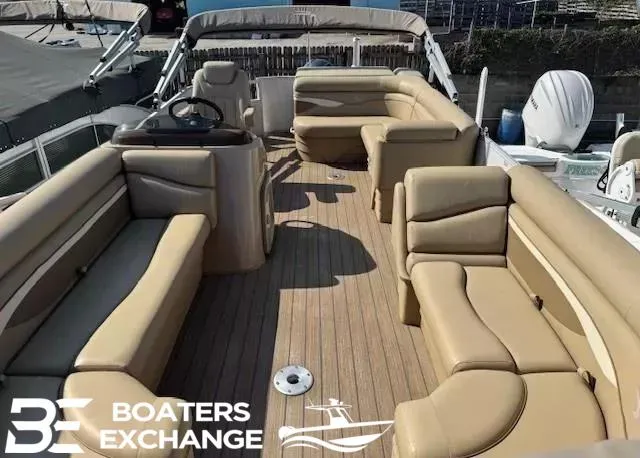 Slide: The Image of 2017 Bennington 21SLX pontoon boat with tan seating and wood-style flooring. - 8