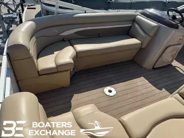 Slide: The Image of 2017 Bennington 21SLX boat interior with tan seating and wood flooring. - 9