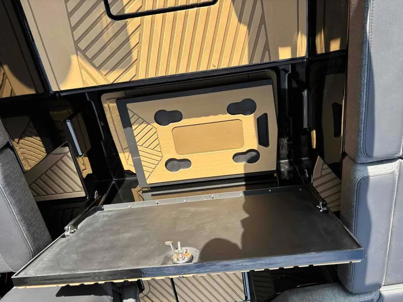 Slide: The Image of 2025 MasterCraft XSTAR23 interior with sleek, modern design and foldable table feature. - 14