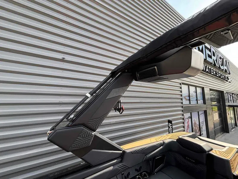 Slide: The Image of 2025 MasterCraft XSTAR23 boat with sleek design near a modern building. - 17