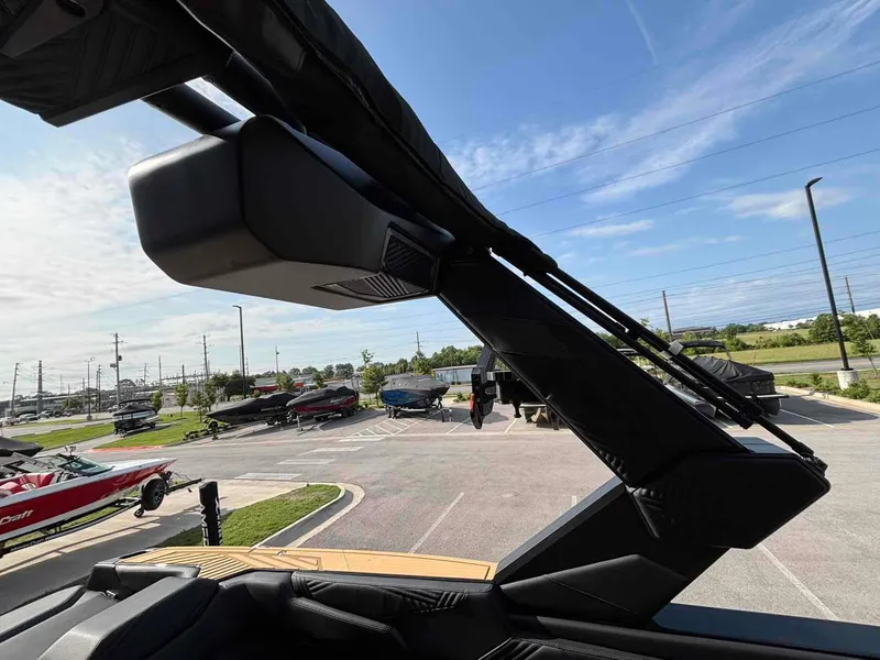 Slide: The Image of 2025 MasterCraft XSTAR23 boat with sleek design, parked in a sunny lot. - 18