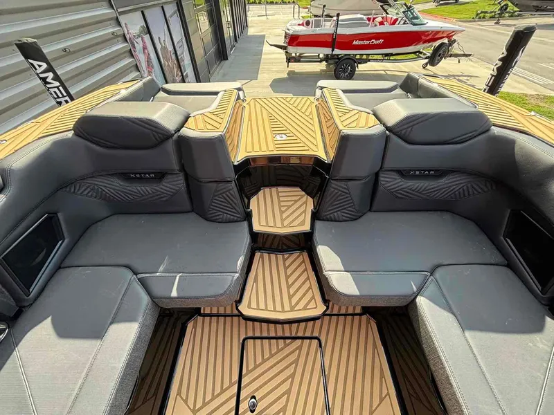Slide: The Image of 2025 MasterCraft XSTAR23 boat interior with sleek seating and modern design. - 19