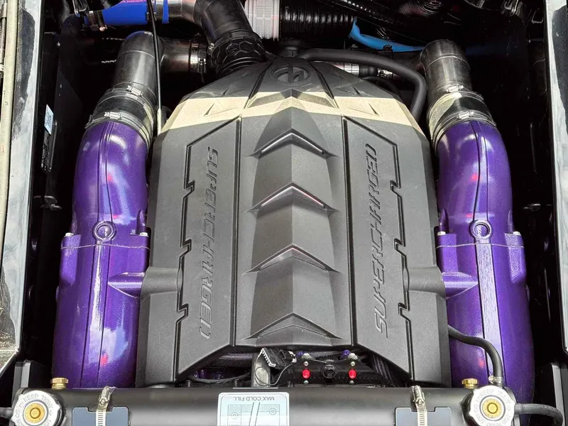 Slide: The Image of 2025 MasterCraft XSTAR23 supercharged engine with purple accents. - 21