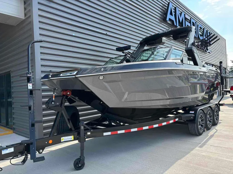Slide: The Image of 2025 MasterCraft XSTAR23 boat on trailer outside dealership. - 4