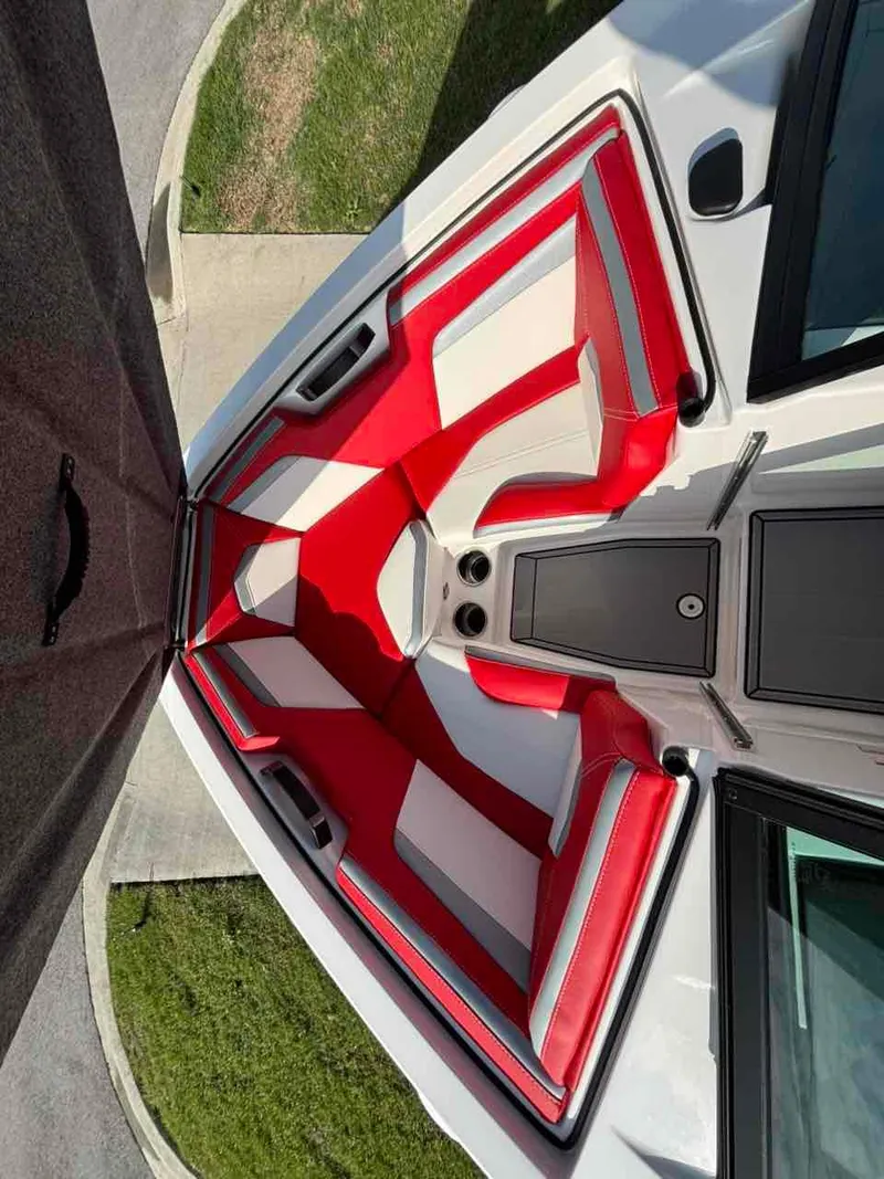 Slide: The Image of 2025 MasterCraft ProStar boat interior with red and white seating, viewed from above. - 10