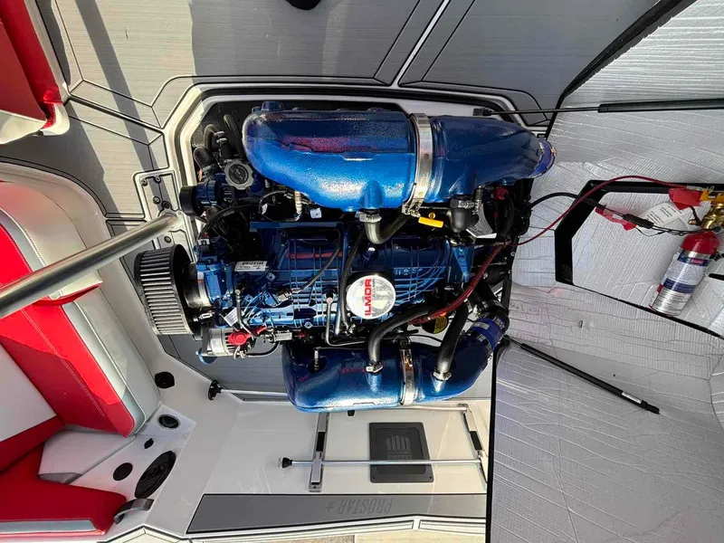 Slide: The Image of 2025 MasterCraft ProStar engine compartment with blue engine and red seating. - 5