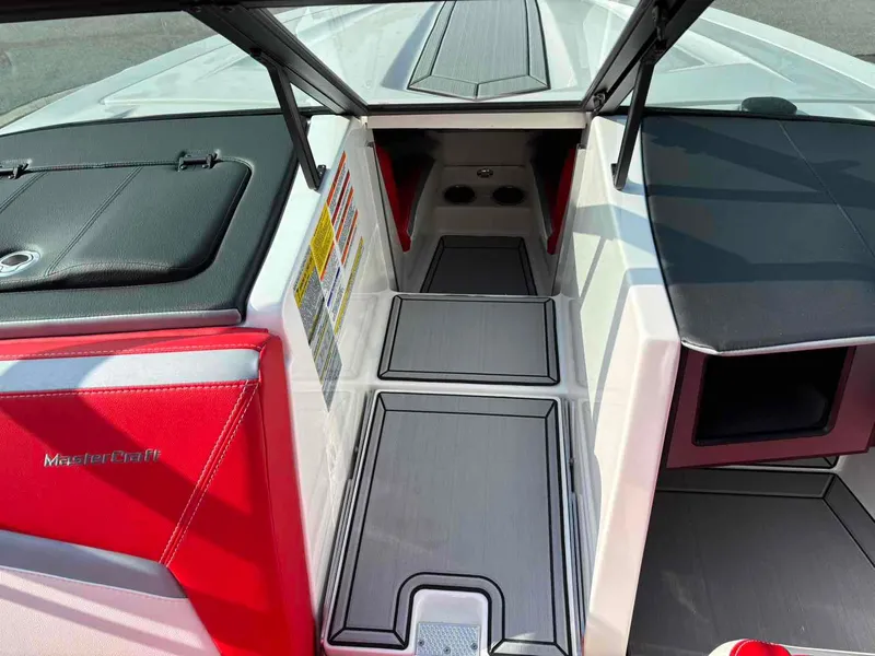Slide: The Image of 2025 MasterCraft ProStar interior with red and black accents, showcasing sleek design and storage space. - 9