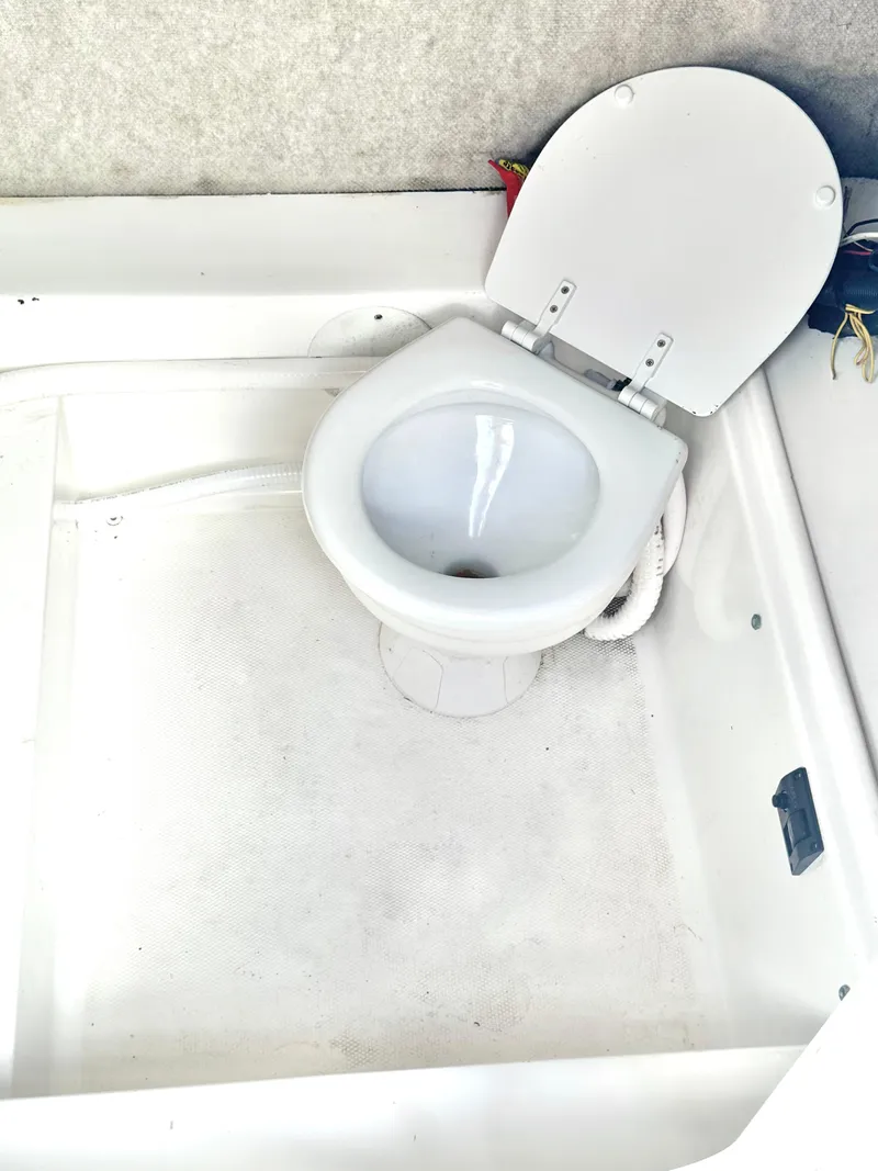 Slide: The Image of 2005 Sea Fox 287 Center Console boat toilet in white compartment. - 10