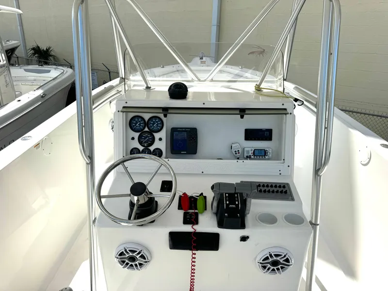 Slide: The Image of 2005 Sea Fox 287 Center Console boat dashboard with steering wheel and navigation instruments. - 14