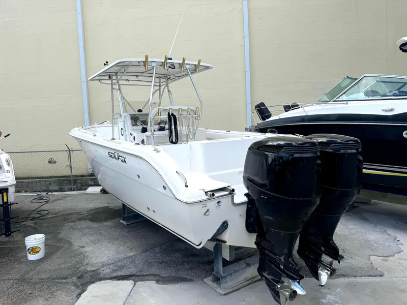 Slide: The Image of 2005 Sea Fox 287 Center Console boat with dual outboard motors on display. - 3