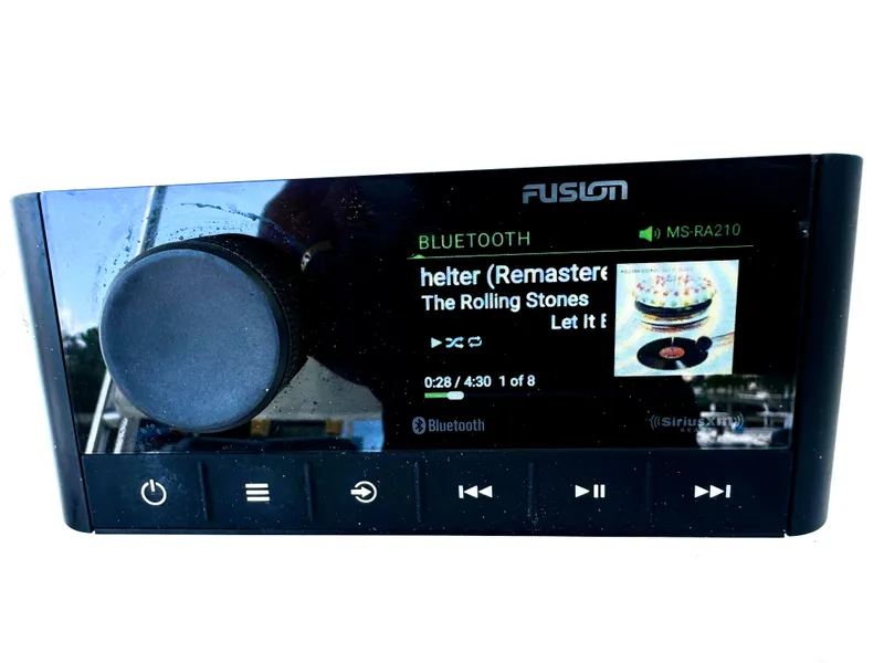 Slide: The Image of Fusion MS-RA210 stereo displaying "Gimme Shelter" by The Rolling Stones on a Sea Fox 287 Center Console. - 4