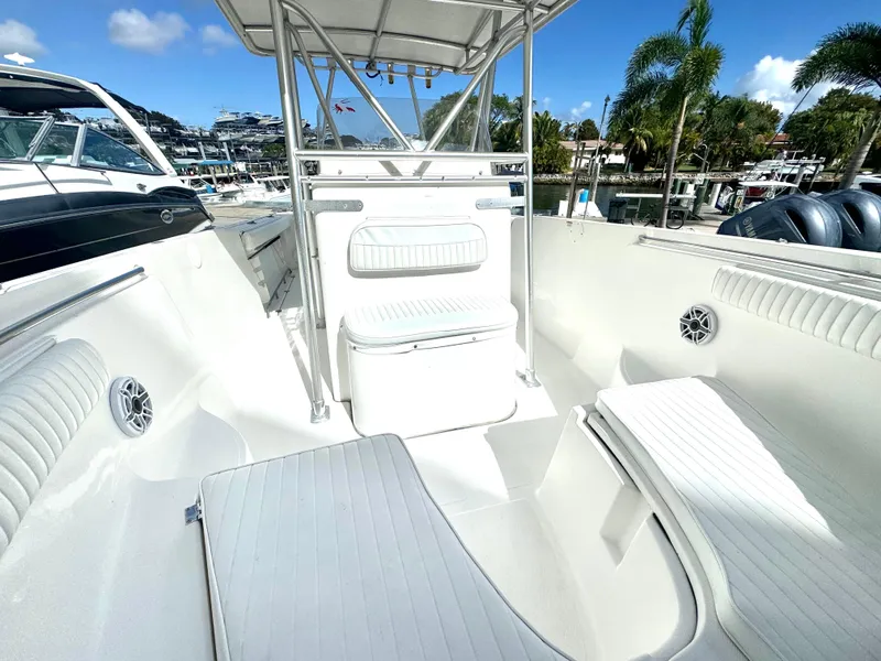 Slide: The Image of 2005 Sea Fox 287 Center Console boat interior with seating and console, docked at marina. - 9