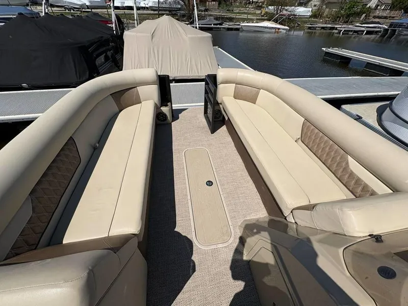 Slide: The Image of 2020 Crest Classic DLX 240 SLC pontoon boat with beige seating and carpeted deck. - 5