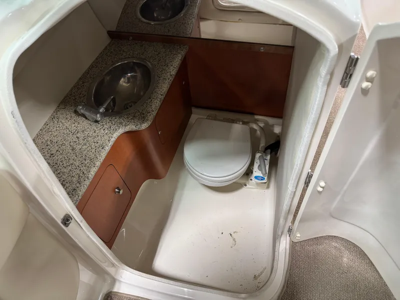 Slide: The Image of 2005 Chaparral 256 SSi boat bathroom with sink and toilet. - 14