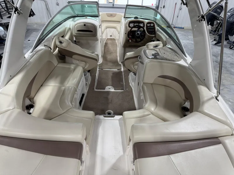 Slide: The Image of 2005 Chaparral 256 SSi boat interior with beige seating and modern dashboard. - 6