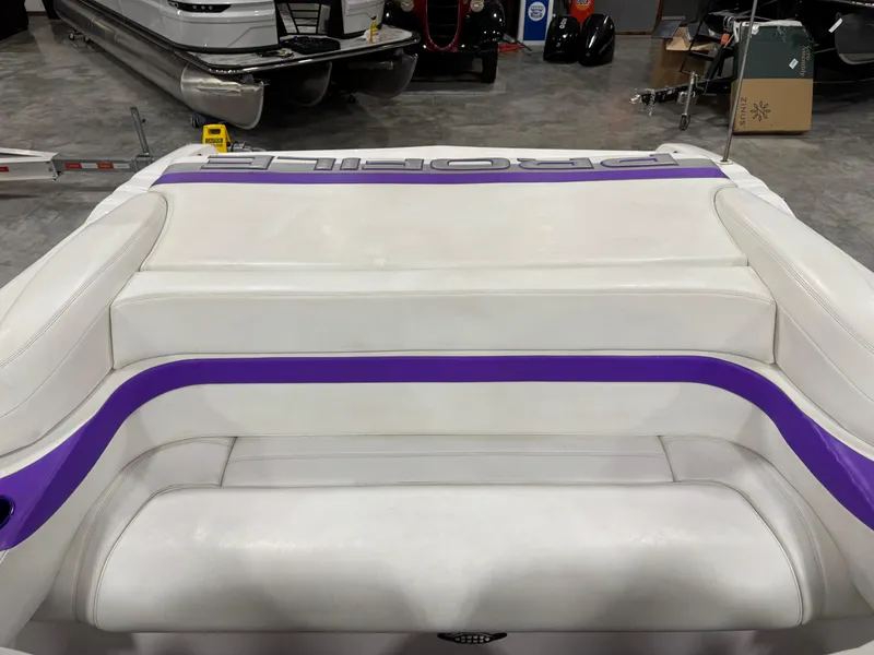 Slide: The Image of White and purple boat seating, Profile 290 model, 2003, in a showroom setting. - 14