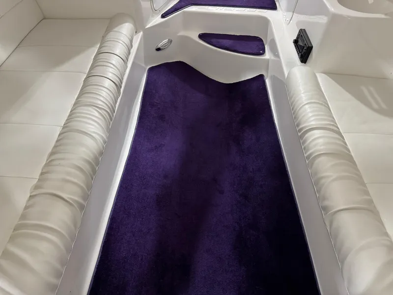 Slide: The Image of Interior of 2003 Profile 290 boat with purple carpet and white seating. - 15