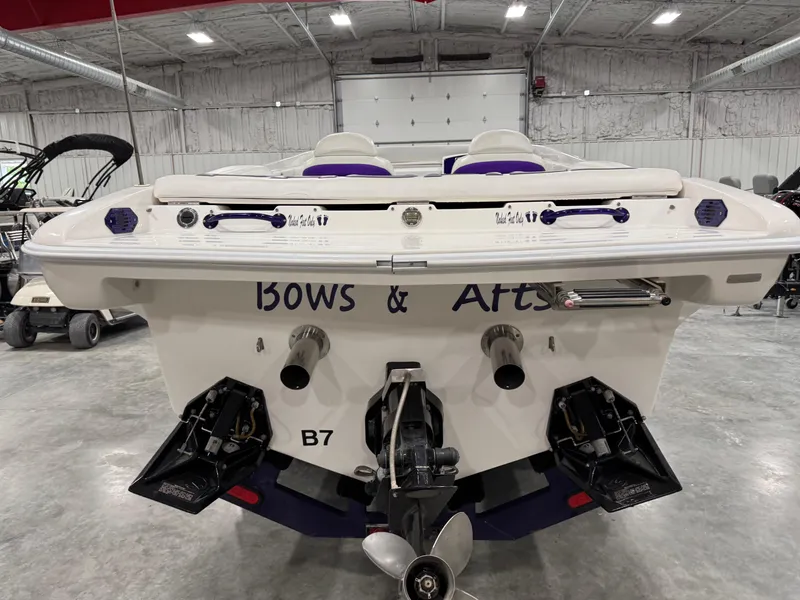 Slide: The Image of Rear view of a 2003 Profile 290 boat in a warehouse setting. - 4