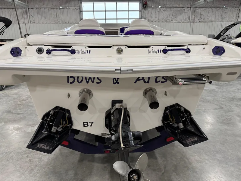 Slide: The Image of Rear view of a 2003 Profile 290 boat in a garage setting. - 6