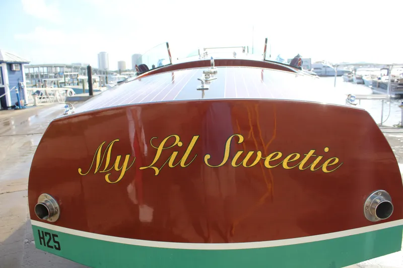 Slide: The Image of 2017 Hacker-Craft 30 boat named "My Lil Sweetie" docked at a marina. - 12