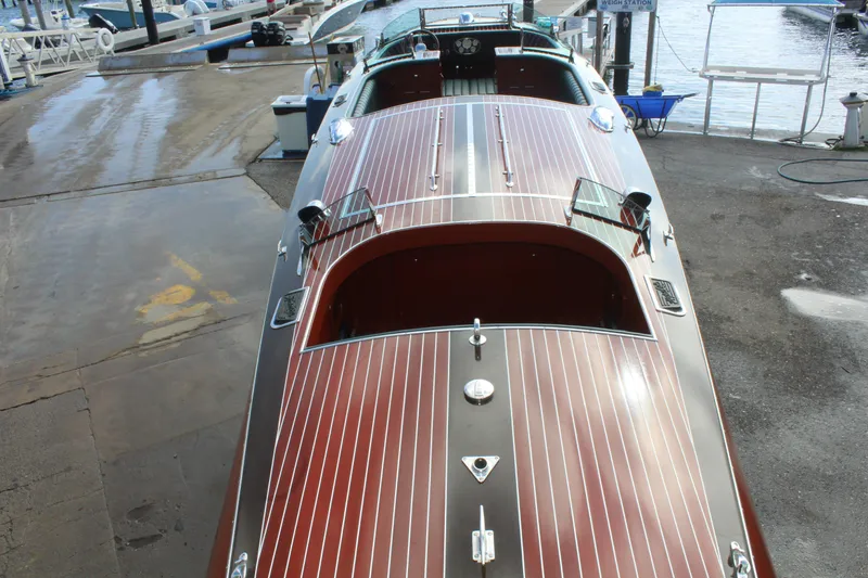 Slide: The Image of 2017 Hacker-Craft 30 boat with polished wooden deck at marina. - 13