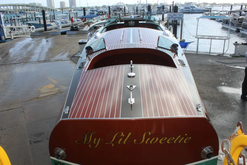 Slide: The Image of 2017 Hacker-Craft 30 boat named "My Lil Sweetie" docked at a marina. - 15