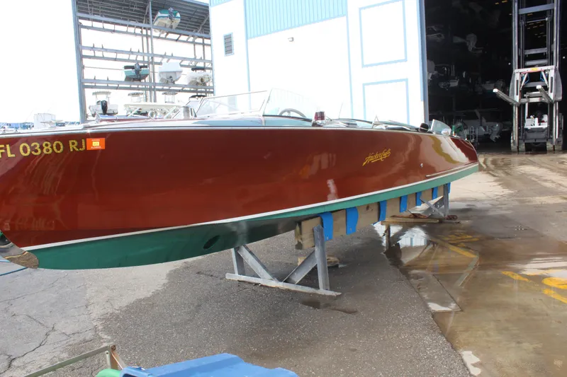 Slide: The Image of 2017 Hacker-Craft 30 boat on a stand, showcasing sleek design and polished wood finish. - 19