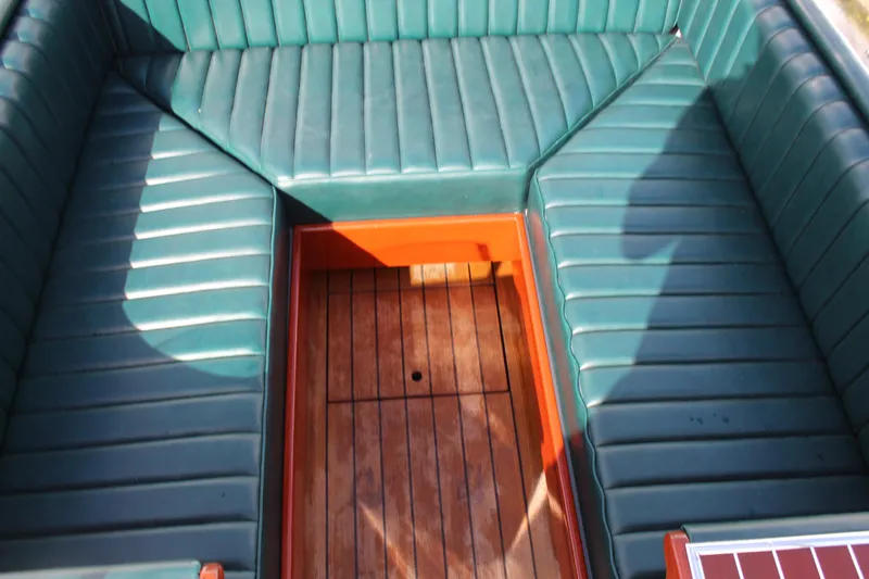Slide: The Image of Luxurious 2017 Hacker-Craft 30 boat interior with green leather seating and wooden flooring. - 6