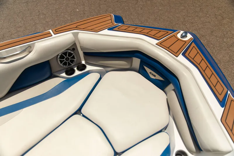 Slide: The Image of Interior of 2015 Axis 22 boat with cushioned seating and speaker system. - 11