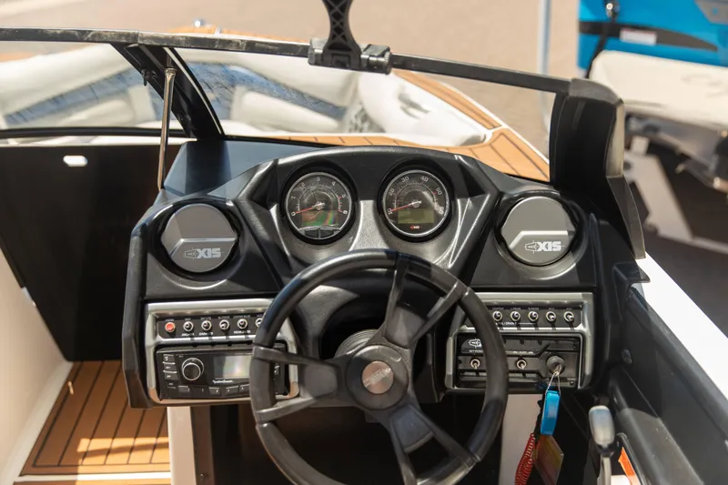 Slide: The Image of Dashboard of a 2015 Axis 22 boat with steering wheel and control panel. - 5