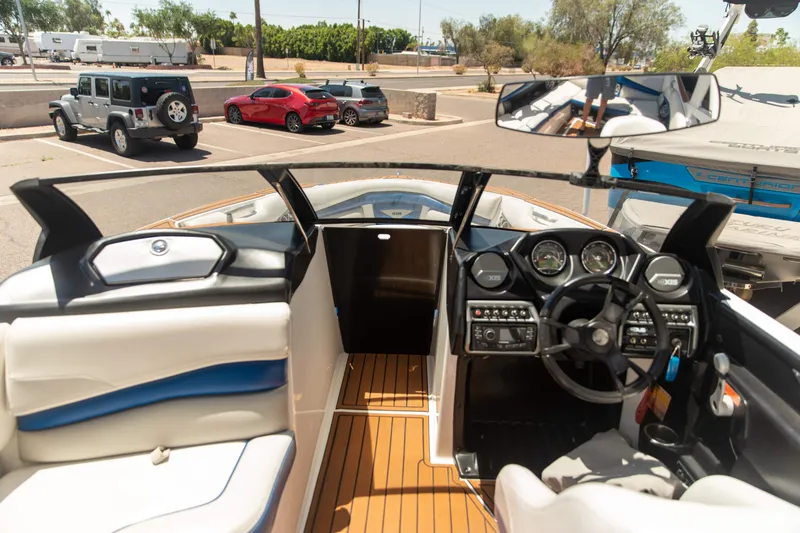 Slide: The Image of Interior view of a 2015 Axis 22 boat with dashboard and steering wheel. - 6