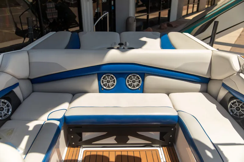 Slide: The Image of Luxurious seating area on a 2015 Axis 22 boat with blue and white upholstery. - 8