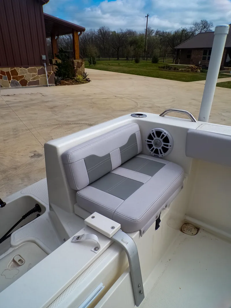 Slide: The Image of 2025 Mako 214CC boat interior with cushioned seating and speaker. - 11