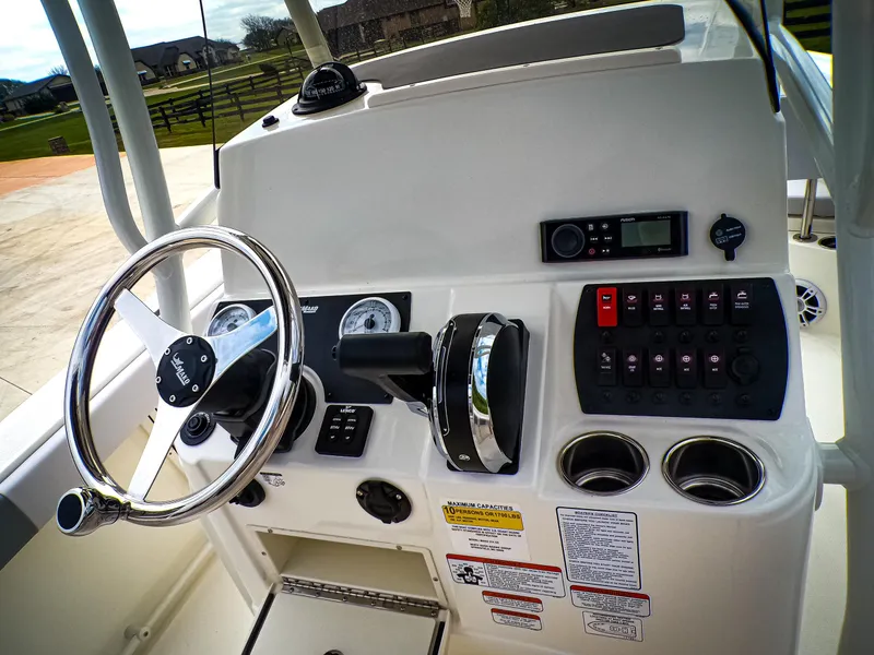 Slide: The Image of Helm of 2025 Mako 214CC boat with steering wheel and control panel. - 6