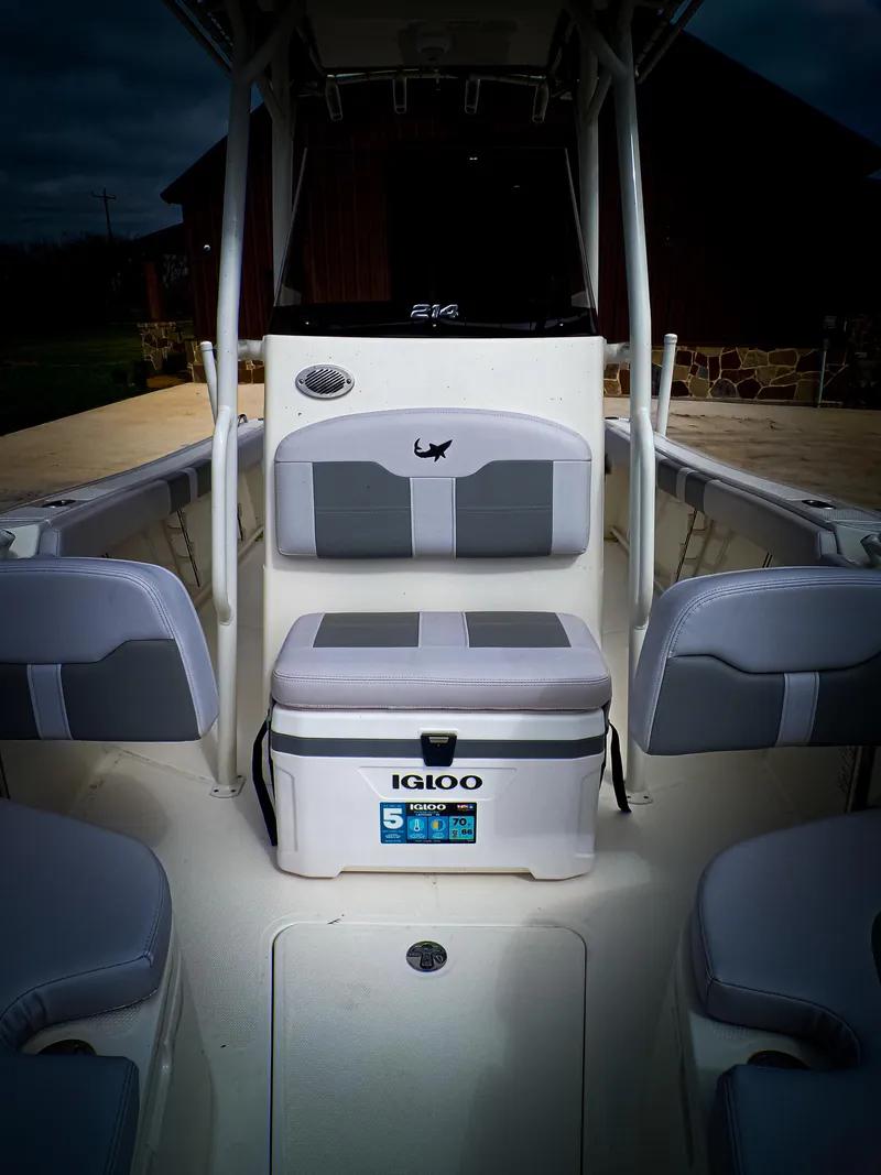 Slide: The Image of 2025 Mako 214CC boat interior with seating and cooler, showcasing modern design and functionality. - 7
