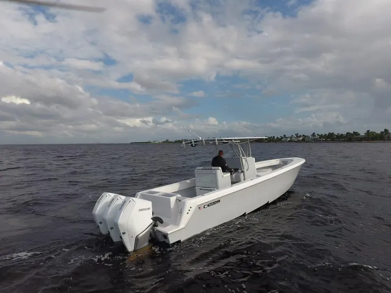 The Image of 2021 Contender 35 ST boat cruising on open water under cloudy skies. - 0