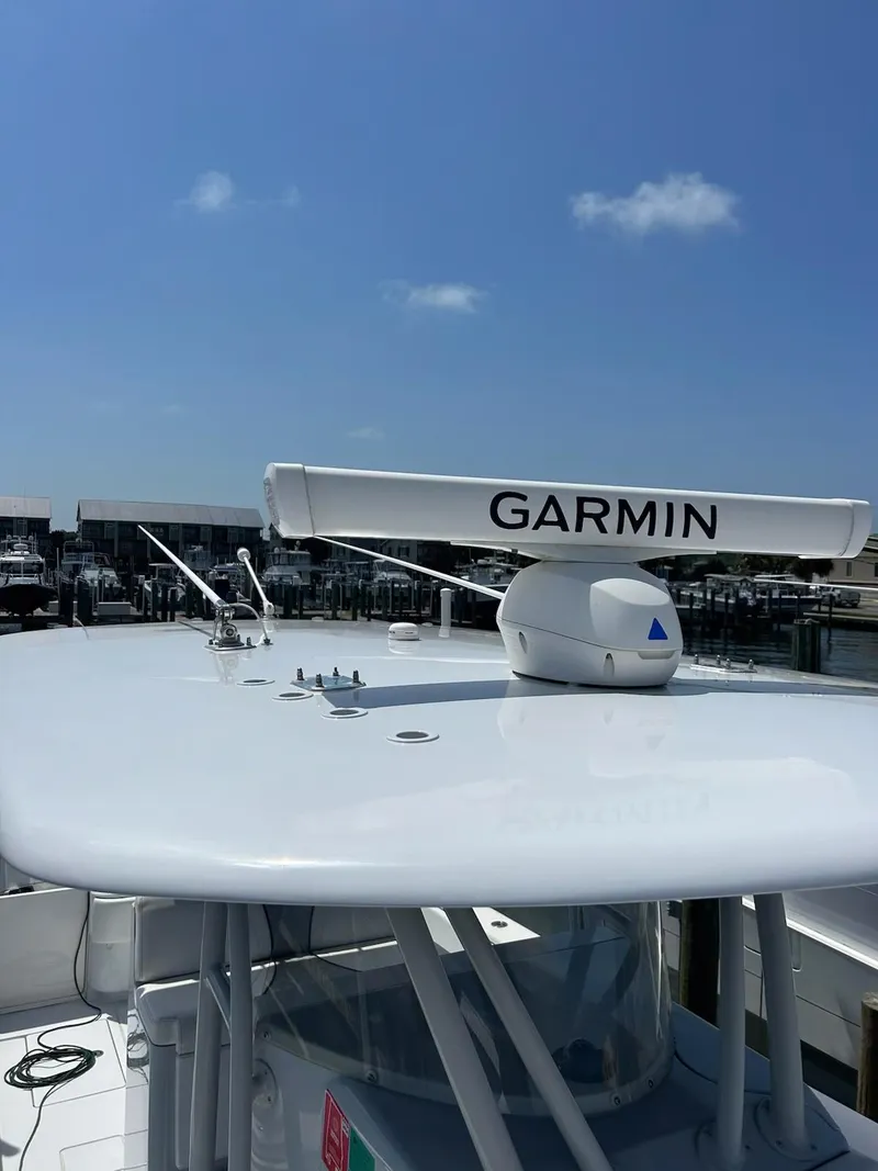 Slide: The Image of 2021 Contender 35 ST boat with Garmin radar, docked under clear blue sky. - 10