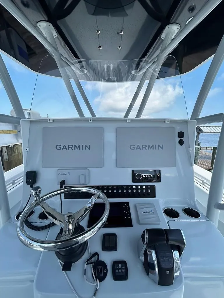 Slide: The Image of 2021 Contender 35 ST boat dashboard with Garmin navigation system and steering wheel. - 5
