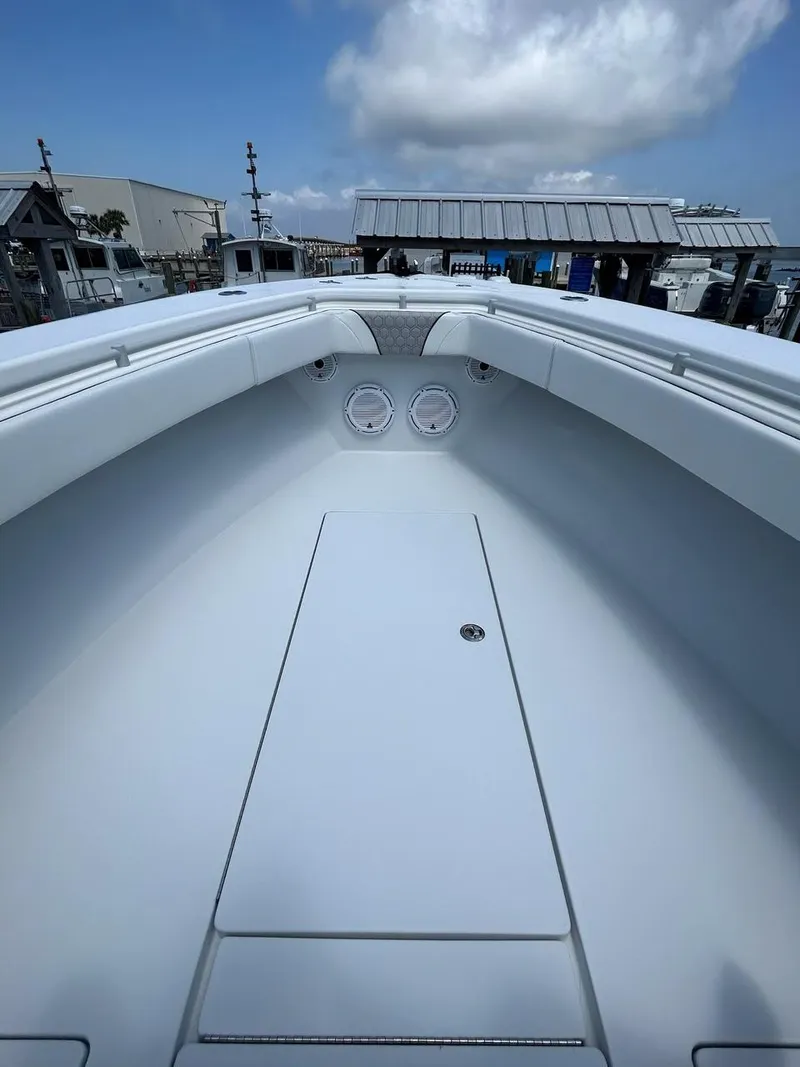 Slide: The Image of 2021 Contender 35 ST boat deck with clear sky and marina background. - 7