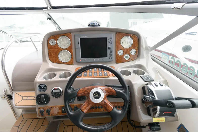 Slide: The Image of 2006 Rinker 390 Express Cruiser dashboard with steering wheel and navigation controls. - 10