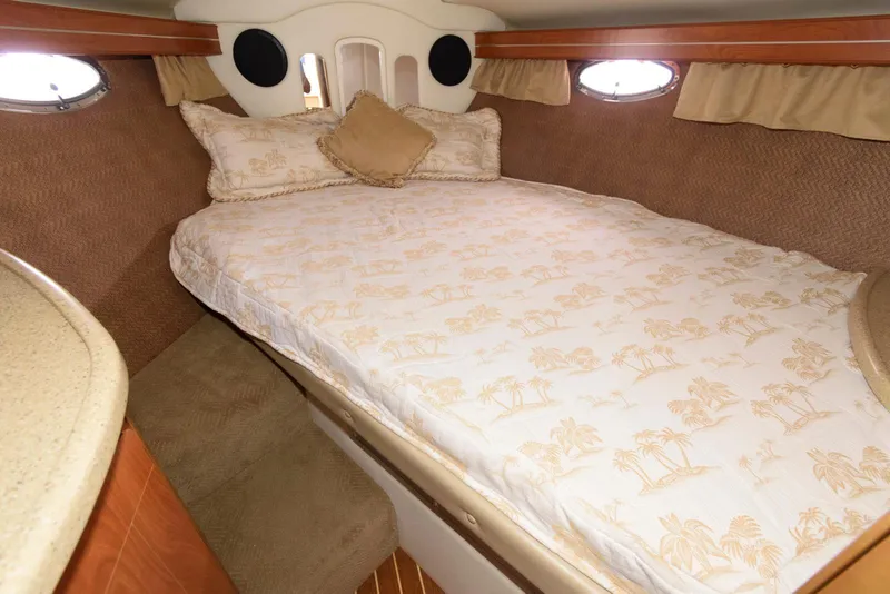 Slide: The Image of 2006 Rinker 390 Express Cruiser cabin with cozy bed and elegant decor. - 15