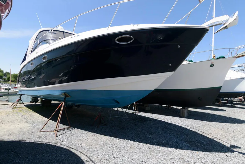 Slide: The Image of 2006 Rinker 390 Express Cruiser on dry dock, side view, sunny day. - 2