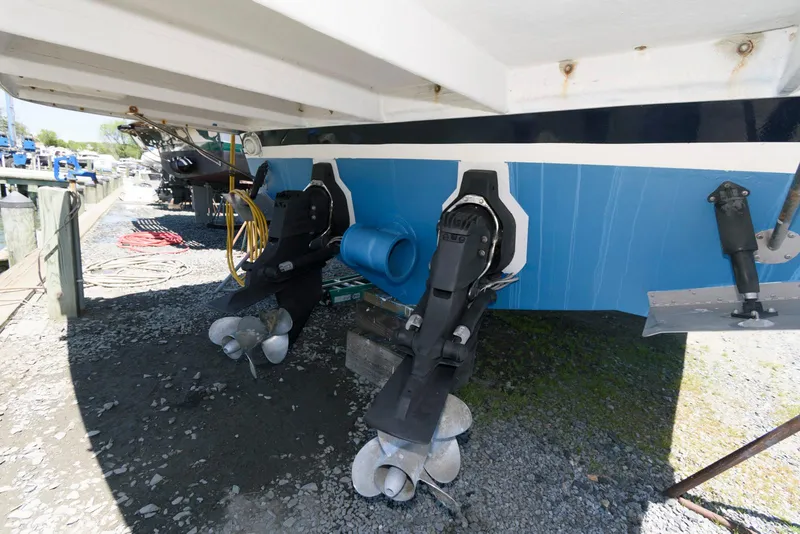 Slide: The Image of 2006 Rinker 390 Express Cruiser with dual outboard motors on dry dock. - 22