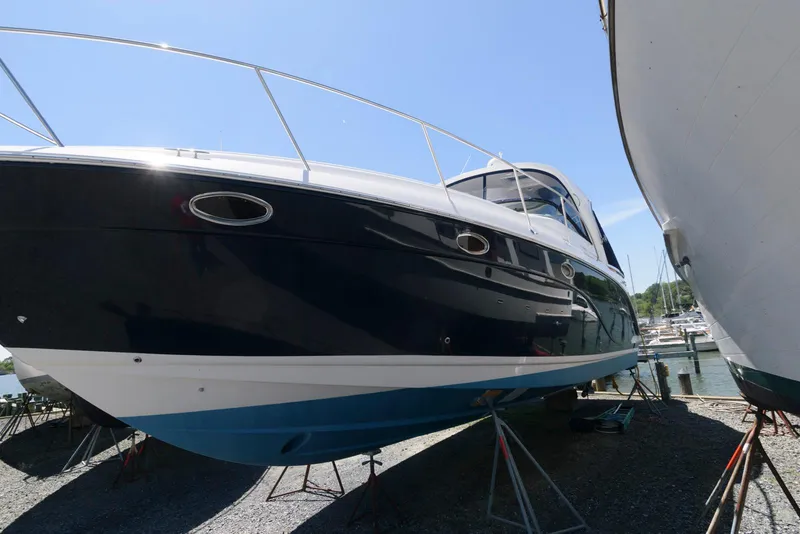 Slide: The Image of 2006 Rinker 390 Express Cruiser boat on stands, side view, sunny day. - 3