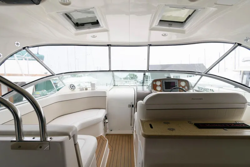 Slide: The Image of 2006 Rinker 390 Express Cruiser interior with helm, seating, and panoramic windows. - 5