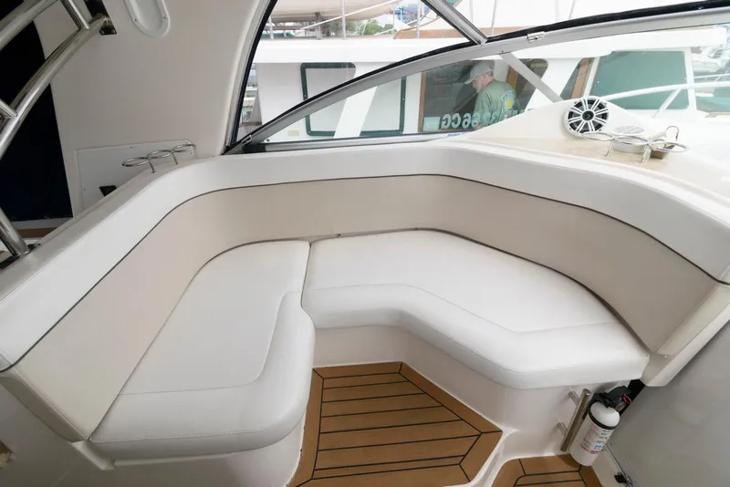 Slide: The Image of 2006 Rinker 390 Express Cruiser interior with white seating and wooden flooring. - 6