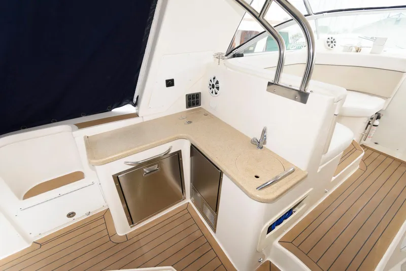 Slide: The Image of 2006 Rinker 390 Express Cruiser interior with kitchenette, featuring sleek countertops and modern appliances. - 7