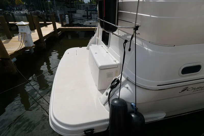 Slide: The Image of 1999 Cruisers Yachts 3750 Motoryacht docked, showing rear deck and mooring lines. - 10