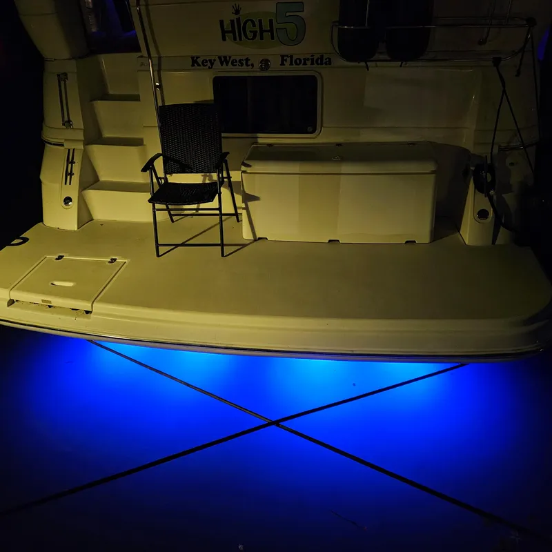 Slide: The Image of 1999 Cruisers Yachts 3750 Motoryacht with blue underwater lights, docked in Key West, Florida. - 14