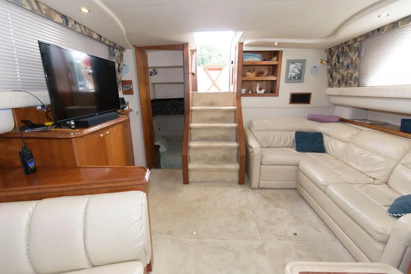 Slide: The Image of 1999 Cruisers Yachts 3750 Motoryacht interior with beige leather seating and entertainment area. - 19